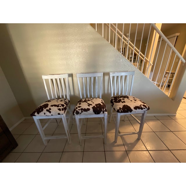 Bring a touch of country charm to your kitchen or bar with this set of three cute farmhouse -stlye barstools! Featuring...