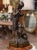 Place this tall patinated sculpture on a console or a buffet! Crafted in Belgium in 1932, the metal statue depicts a young...