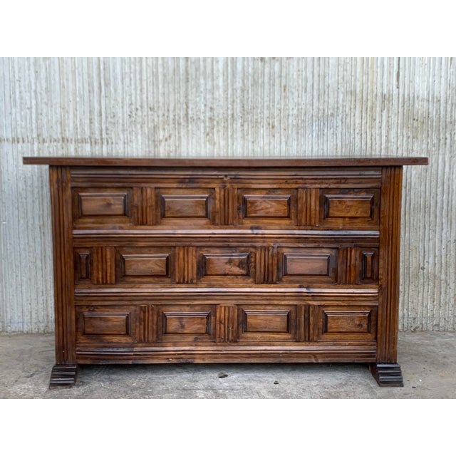 20th Spanish trunk with raised wooden panels and original iron hardware A Spanish carved wood blanket chest from the 20th...