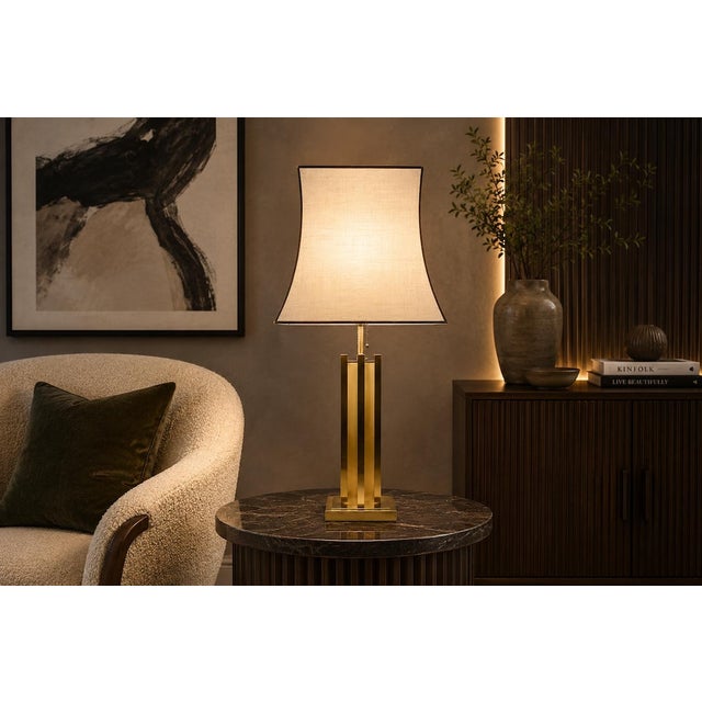 A striking and sculptural table lamp, embodying the bold geometric glamour of 1970s Italian design. The lamp features a...