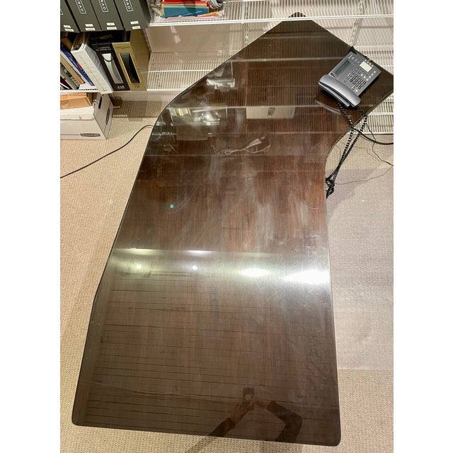 A beautiful mid-century desk and credenza from the Alma Furniture Company, complete with glass tops. The desk has a pull...