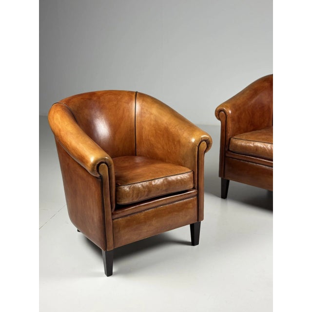 Set of two sheepskin club armchairs. In absolute mint condition! Beautiful color and patina. Dimensions: 76W x 80D x 83H 48sh