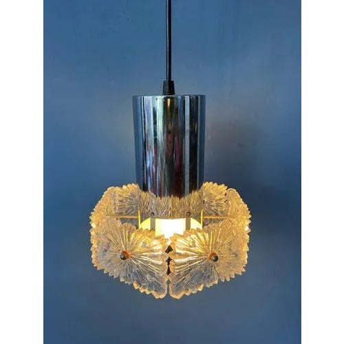 Mid century pendant lamp with crystal glass shade. The light reflects nicely through the rough relief of the glass...