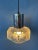 Mid century pendant lamp with crystal glass shade. The light reflects nicely through the rough relief of the glass...