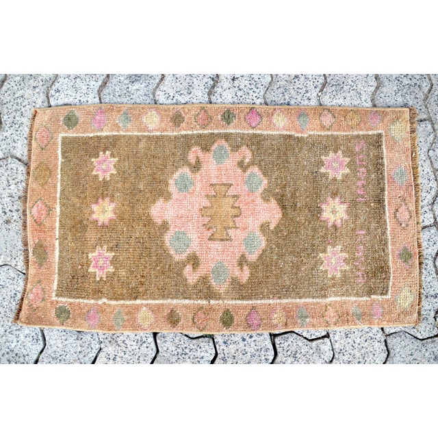 This is a vintage Turkish Oushak rug from the 1960s. The piece was hand-knotted.