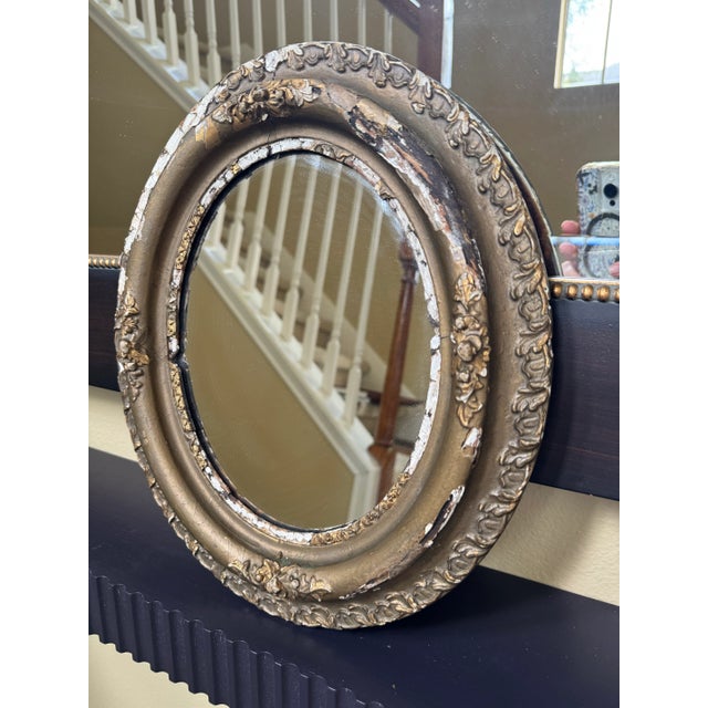 The aged finish is shining through on this antique French Baroque style mirror. The patina of the golden bronze finish...