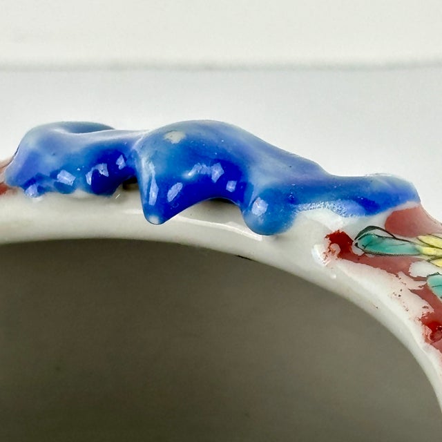 A striking late‑19th to early‑20th century Chinese porcelain brush pot, distinguished by its vivid famille‑rose decoration...