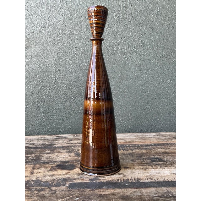 This vintage handcrafted pottery bottle is a refined example of mid-20th-century studio ceramic design, distinguished by...