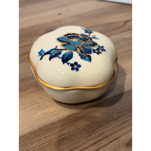 • Material: Fine white porcelain • Design: Five-sided scalloped shape with a matching lid • Decoration: Hand-decorated...