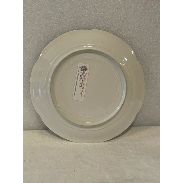 Pair. Beautiful hand painted English porcelain plates with birds on a white ground with a green laurel border. Gold gilt...