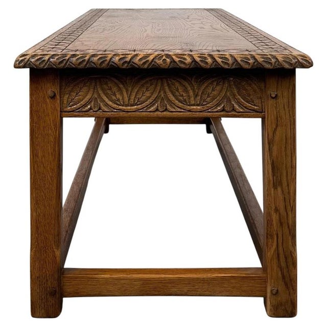 A handsome and beautifully crafted early 20th-century English Edwardian coffee table, constructed in golden oak and...