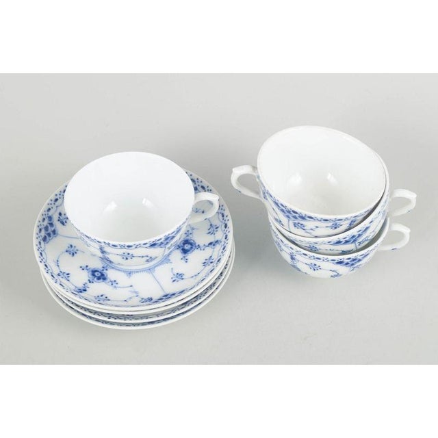 Royal Copenhagen Blue Fluted Half Lace coffee cups with saucers, set of four. Coffee cups with matching saucers in...