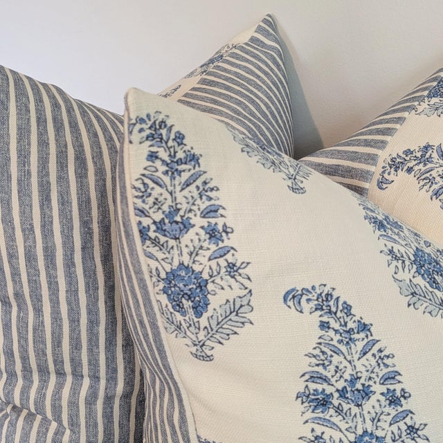 Katie Leede Mughal Gardens paisley floral pillow in blues on a white background, with coordinating blue and white striped...