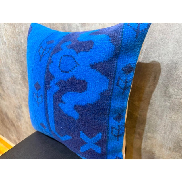 Cut from the border region of a vintage hand-knotted Anatolian rug, this square cover preserves the asymmetry of its...