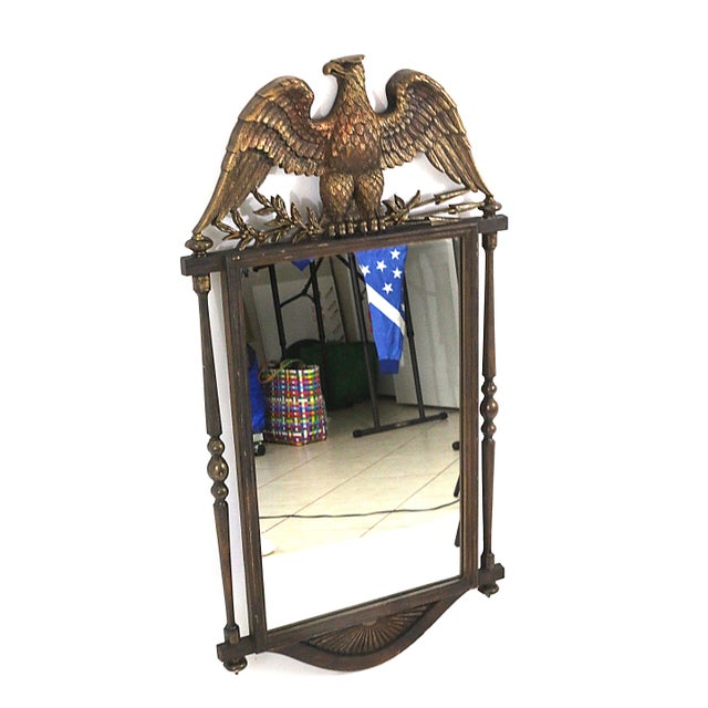 A vintage, mirror by Burwood Products with colonial details and large bald eagle with branches and arrows in the talons....