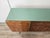 This 1960s-style sideboard features an elegant and sophisticated design, clad in fine mahogany burl that highlights the...