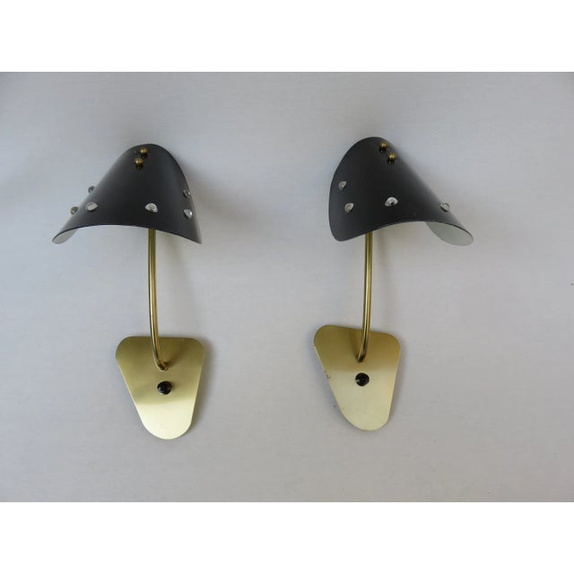 A pair of elegant and exceptional wall lights made in Italy in the 50s. The lampshades are made of black painted aluminum...