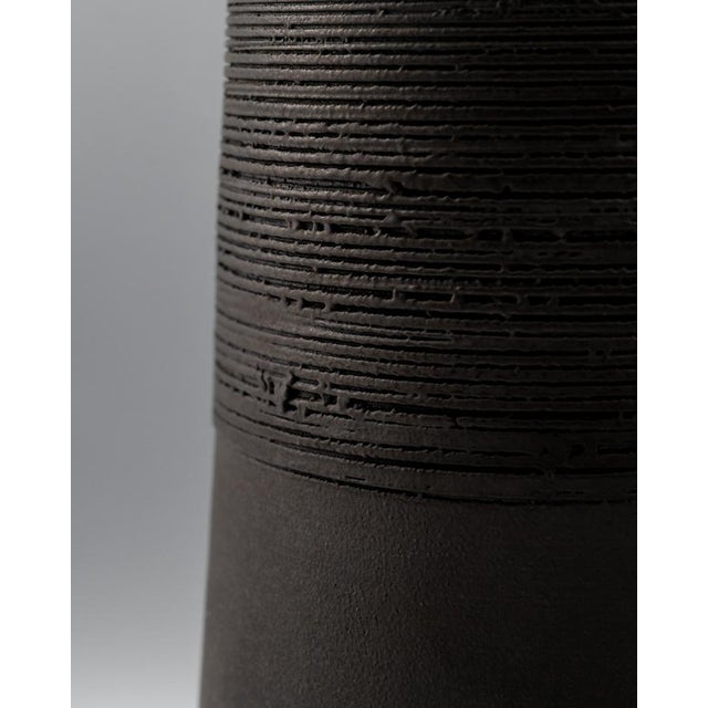 A quietly expressive bottle vase in Shigaraki stoneware, signed Atsushi Yuba and made in Japan in the 1980s. The form is...