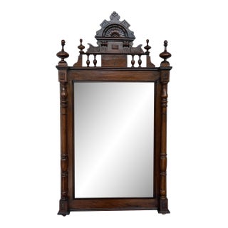 Early 20th French Ebonized Mirror with Turned Columns and High Carved Details For Sale