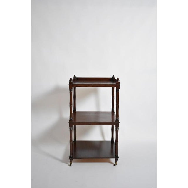 Faux bamboo bookshelves pedestal table, 1960s. Three-tiered square bookcase side table in natural wood imitating bamboo....