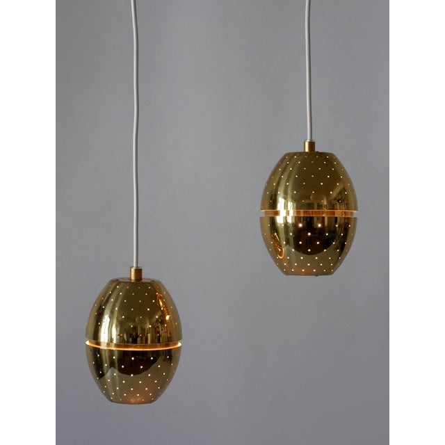 Set of two rare, lovely and highly decorative mid-century modern egg-shaped perforated brass 'florina t790' pendant lamps...