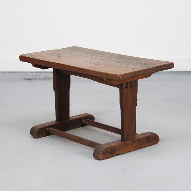 This small antique coffee table is made from solid oak with a base crafted from a reused flax tool. Over the years, it has...