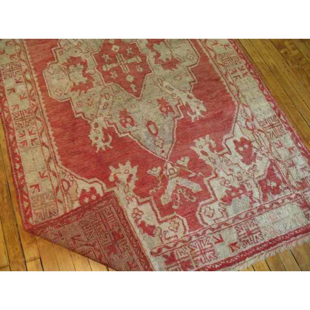 Accent size Turkish Oushak rug with a red background accents light green ivory and gray. Measures: 4'2'' x 6'9''.