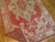 Accent size Turkish Oushak rug with a red background accents light green ivory and gray. Measures: 4'2'' x 6'9''.