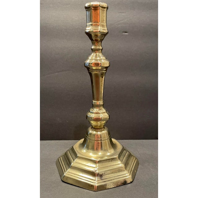 Antique brass French Louis XIV candlestick. Octagonal baluster form with a paneled candle cup. Circa 1680-1720. Unmarked....
