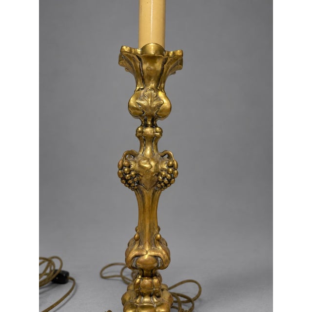 A pair of Continental, probably French, gilt-metal table lamps or electrified candlesticks, late 19th to early 20th...