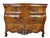 With serpentine top over three drawers with original handles and a carved floral pierced apron raised on carved scrolled...