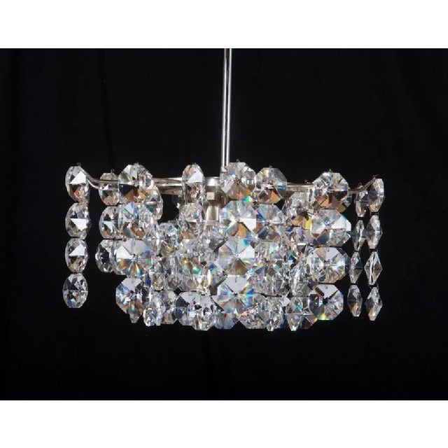 - Nickel-plated brass frame with cut crystal elements - Three layered - Fitted with nine E14 sockets - Made in Austria -...