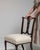 A side chair whose dark mahogany carved back, cream upholstered seat gives it real character at first glance. It was made...