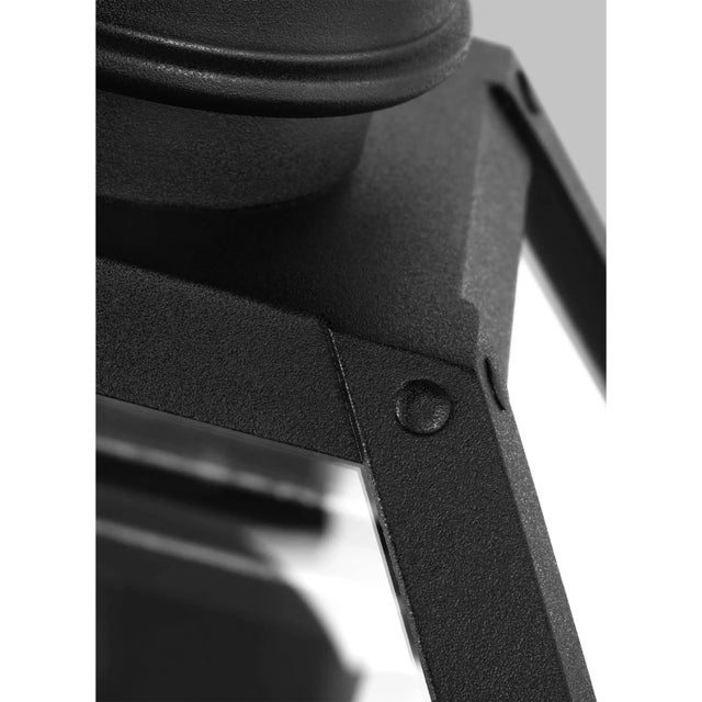 The Hyannis three light outdoor wall fixture in textured black by Chapman & Myers has a classic copper lantern profile...