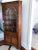 Vintage antique style early American corner cabinet by Statton with an arched, glass door, four shelves and a single...