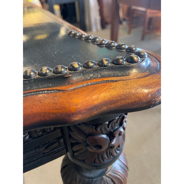A solid hardwood Old Hickory game table that showcases a Western motif, accented with nail trim, fluted legs, and an...