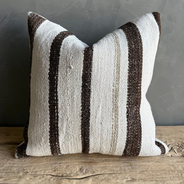 Creamy white hemp rug pillow with stripes. Soft hand, linen blend backing with zipper closure. Spot cleaning is...