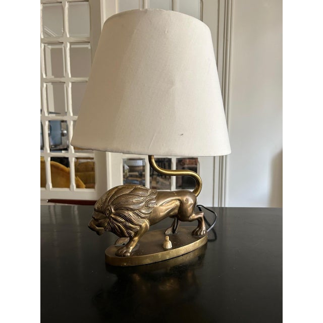 1970s brass lamp with a stained lampshade Base width 23cm, height 20cm, depth 8cm European Plug (up to 250V).The wiring of...