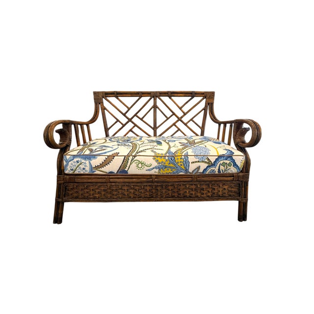 Charming vintage Chippendale-style bamboo and rattan settee featuring an intricate geometric lattice back, gracefully...