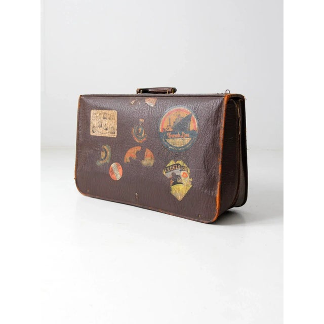 This is a vintage leather suitcase circa 1930s. The "Tour-Aider" luggage crafted by K.Kaufmann & Co features a thick brown...