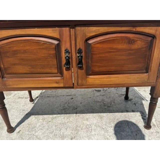 This is an antique townhouse washstand. An English, oak and granite bathroom cabinet in Arts & Crafts taste, dating to the...