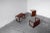 Set of three nesting tables by Punch Design Inc., rectangular sled legs rise slightly above the tabletop, forming a small...