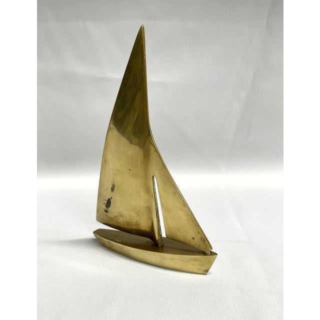 A large solid brass sailboat, perfect for beach house or mid-century modern decor. Bookshelf ready with lovely patina.