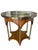 Elegant early 20th century accent table featuring a striking reverse-painted églomisé glass top with layered gold leaf and...