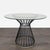 This Pottery Barn dining set features a sleek round glass table with a sturdy black metal wire base and brass accents. The...