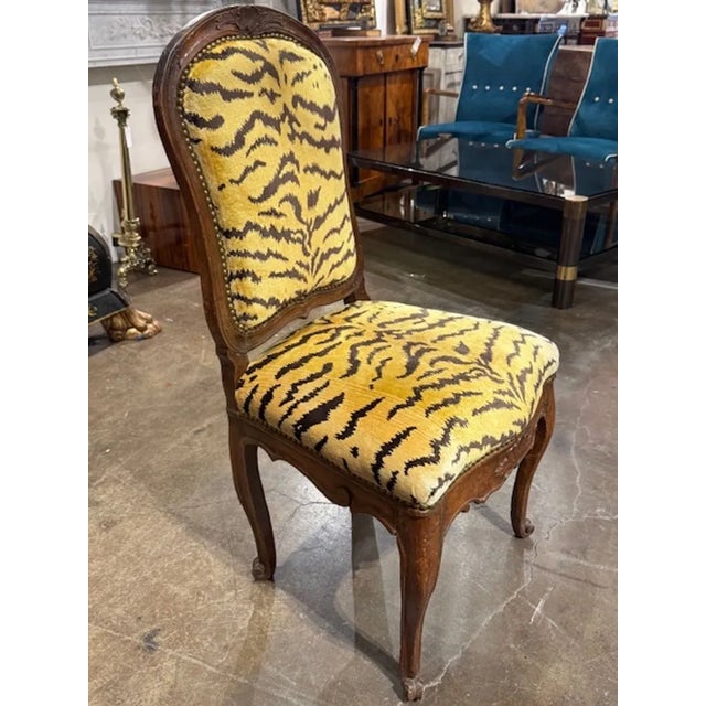 This 18th century French Provincial carved walnut side chair is a beautifully crafted piece of furniture designed for...