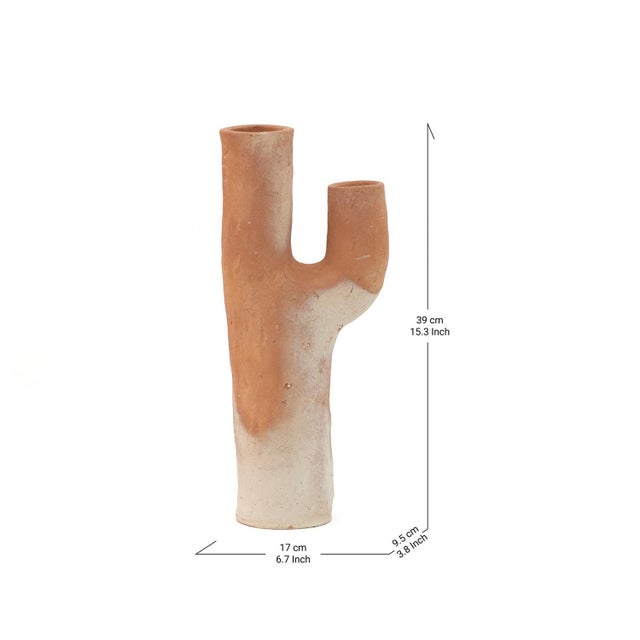 Two uneven openings rise from a single tapered stem in this Tamegroute sculpture, its warm terracotta body shifting into...