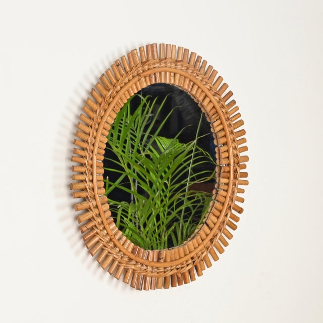 Marvelous French Riviera style round mirror in bamboo, curved rattan, and hand-woven wicker. This delightful organic...