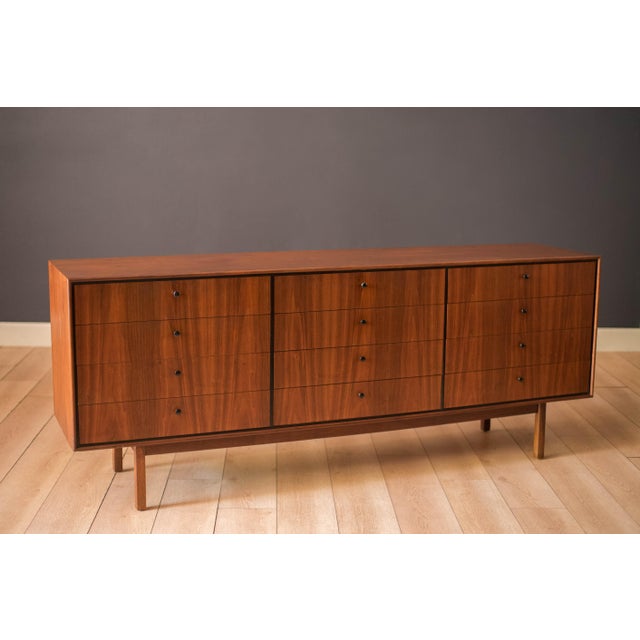 Vintage triple dresser chest designed by Jack Cartwright for Founders Company, circa 1960s. Features natural walnut...