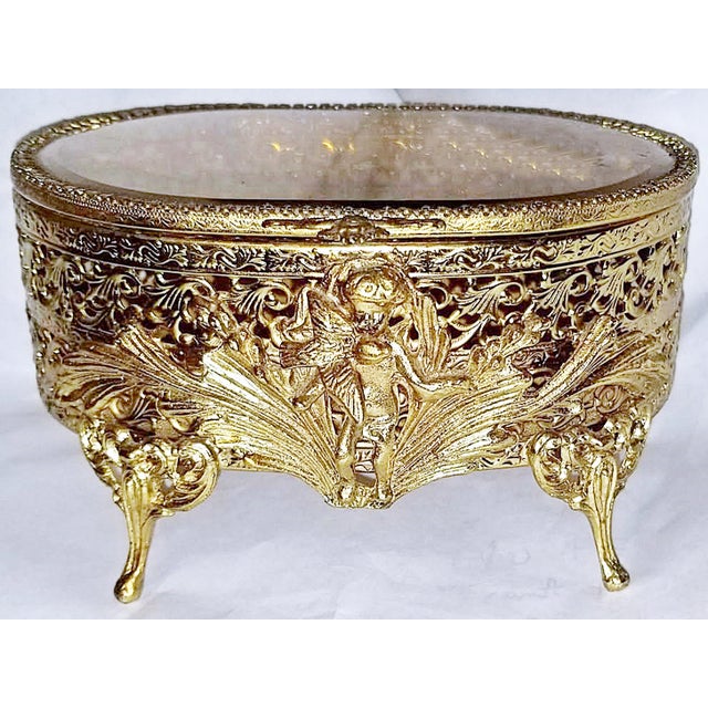 The Golden Era comes alive with this 1930-40s 23k gold plated ormolu brass filigree jewelry box with beveled amber glass...